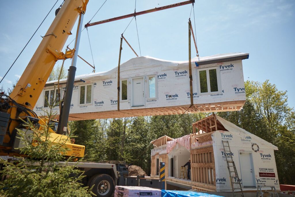 modular house being installs using crane