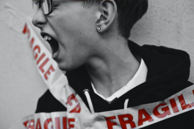 boy tie with trespass band with fragile written on it