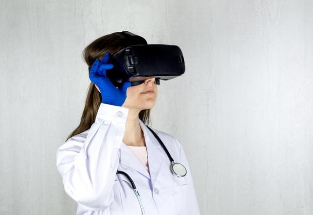 female doctor with stethoscope in neck and vr headset on face