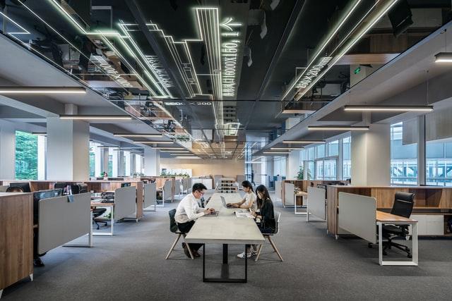 man and women working in a spacious modern office space