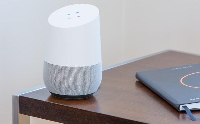 white and gray  google home virtual assistant