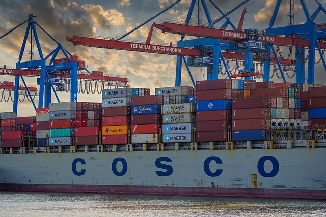 huge container ship being unloaded with crane