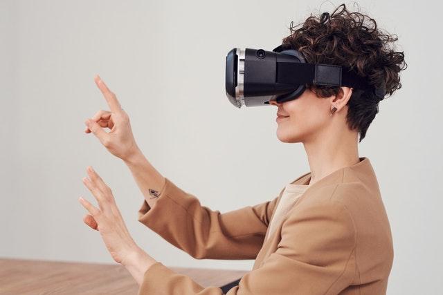 woman wearing virtual reality google and doing gesture with hand