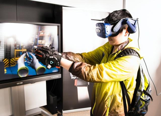 a boy fully immerse in a virtual world with extended reality gear